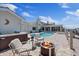 Outdoor patio features a jacuzzi, heated pool, fire pit, and plenty of seating at 5033 Cabrilla Ct, New Port Richey, FL 34652