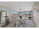 Enclosed porch featuring tile floor, ceiling fan, table, and seating with water views from the multiple windows at 5033 Cabrilla Ct, New Port Richey, FL 34652