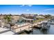 Waterfront property features a pool, hot tub, outdoor seating, boat dock, and lush tropical landscaping at 5033 Cabrilla Ct, New Port Richey, FL 34652
