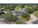 Picturesque aerial view of a clubhouse overlooking a lush green golf course and a tranquil pond at 5110 Championship Cup Ln, Spring Hill, FL 34609