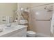 A bathroom featuring a shower with a grab bar, and built in storage for towels at 5110 Championship Cup Ln, Spring Hill, FL 34609