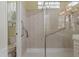 This bathroom boasts a tiled shower with safety bars and a glass block window for added privacy at 5110 Championship Cup Ln, Spring Hill, FL 34609