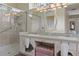 Bright bathroom features a double sink vanity, walk-in shower with a glass door and large decorative mirror at 5110 Championship Cup Ln, Spring Hill, FL 34609