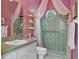 Unique bathroom with pink walls, and a shower with green tile at 5110 Championship Cup Ln, Spring Hill, FL 34609