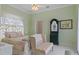 Bedroom featuring bed, side table, secretary, and light green walls at 5110 Championship Cup Ln, Spring Hill, FL 34609