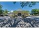 View of clubhouse entrance with decorative landscaping and circular drive, offering a welcoming approach at 5110 Championship Cup Ln, Spring Hill, FL 34609