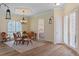 Bright dining room featuring a chandelier, many windows, and a view into a bedroom at 5110 Championship Cup Ln, Spring Hill, FL 34609