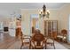 Inviting dining room features a chandelier, a glass table, and views to the kitchen at 5110 Championship Cup Ln, Spring Hill, FL 34609