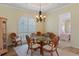 Charming dining area with a chandelier, many windows, and view into another room at 5110 Championship Cup Ln, Spring Hill, FL 34609