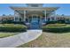Exterior of community clubhouse showing an inviting walkway and manicured landscaping at 5110 Championship Cup Ln, Spring Hill, FL 34609