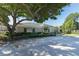 Charming community building with lush landscaping and a mature shade tree at 5110 Championship Cup Ln, Spring Hill, FL 34609