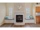Elegant fireplace featuring built-in bench seating and natural light from adjacent windows at 5110 Championship Cup Ln, Spring Hill, FL 34609
