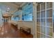 Hallway with wood floors, decorative wall trim, and benches leading to the clubhouse dining area at 5110 Championship Cup Ln, Spring Hill, FL 34609