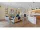 Cozy living room with laminate flooring, a fireplace, and an open view to the kitchen at 5110 Championship Cup Ln, Spring Hill, FL 34609