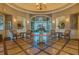 Clubhouse lobby showcasing an elegant chandelier, seating area, and decorative table with floral arrangement at 5110 Championship Cup Ln, Spring Hill, FL 34609