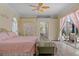 Comfortable main bedroom with ceiling fan, closet space and access to the outdoor patio at 5110 Championship Cup Ln, Spring Hill, FL 34609