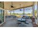 Outdoor seating overlooking the golf course and lake, with ceiling fans for a comfortable experience at 5110 Championship Cup Ln, Spring Hill, FL 34609