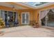 Relaxing screened patio area with ceiling fan, a dining set, and double doors to the interior at 5110 Championship Cup Ln, Spring Hill, FL 34609