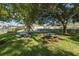 Community picnic area with picnic tables under shade trees, perfect for outdoor gatherings at 5110 Championship Cup Ln, Spring Hill, FL 34609