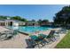 Sparkling community pool with lounge chairs and tables for residents' enjoyment at 5110 Championship Cup Ln, Spring Hill, FL 34609