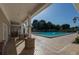 Community pool area with tiled deck, covered seating area, and plenty of sunshine at 5110 Championship Cup Ln, Spring Hill, FL 34609