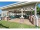 Outdoor seating area with tables and chairs next to community pool at 5110 Championship Cup Ln, Spring Hill, FL 34609