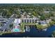 Waterfront condo building with boat dock, and neighboring house with pool on the canal at 5640 Ferguson Ct # 2106, New Port Richey, FL 34652