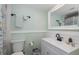 Updated bathroom with a mint green wall, white vanity, and modern fixtures at 5640 Ferguson Ct # 2106, New Port Richey, FL 34652
