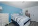 Bright bedroom with a cozy bed, nautical decor, and easy access to the bathroom at 5640 Ferguson Ct # 2106, New Port Richey, FL 34652