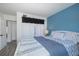 Cozy bedroom featuring blue accent wall, bright light and soft white linens at 5640 Ferguson Ct # 2106, New Port Richey, FL 34652