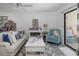 Cozy living room featuring a comfortable sofa, accent chair, and sliding doors leading to the outside at 5640 Ferguson Ct # 2106, New Port Richey, FL 34652