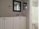 Bathroom with white cabinets and a tub shower combo at 5651 Canosa Dr, Holiday, FL 34690