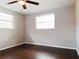 Bedroom featuring wood floors and two windows which brings an abundance of natural light at 5651 Canosa Dr, Holiday, FL 34690