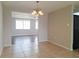 Dining room connected to living spaces, featuring stylish lighting and tile flooring at 5651 Canosa Dr, Holiday, FL 34690