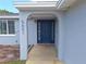 Inviting entryway with a blue front door and covered arch at 5651 Canosa Dr, Holiday, FL 34690