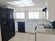 Well-lit kitchen featuring modern appliances and tiled floors at 5651 Canosa Dr, Holiday, FL 34690