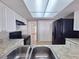 Bright kitchen with modern appliances, tile flooring, and ample counter space at 5651 Canosa Dr, Holiday, FL 34690