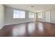 Spacious living room featuring wood floors and multiple windows at 5651 Canosa Dr, Holiday, FL 34690
