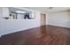 Open living area with hardwood floors and a view of the kitchen at 5651 Canosa Dr, Holiday, FL 34690
