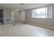 Bright living room features neutral walls, tile flooring, and a front entry at 5651 Canosa Dr, Holiday, FL 34690