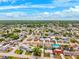 Wide aerial view of a residential neighborhood with tree-lined streets under a bright blue sky at 5706 Mockingbird Dr, New Port Richey, FL 34652