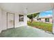 This covered back porch has a private entrance and overlooks the lush backyard at 5706 Mockingbird Dr, New Port Richey, FL 34652