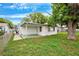 View of the backyard with grass and a patio at 5706 Mockingbird Dr, New Port Richey, FL 34652