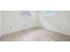 Neutral bedroom with tile flooring, bright windows, and electrical outlets at 5706 Mockingbird Dr, New Port Richey, FL 34652