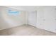 Bedroom featuring tile flooring, closet with sliding doors, and neutral walls at 5706 Mockingbird Dr, New Port Richey, FL 34652