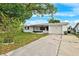 Charming single-story home with a well-maintained front yard, driveway and attached garage at 5706 Mockingbird Dr, New Port Richey, FL 34652
