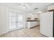 Bright kitchen featuring white cabinetry, tiled floors, modern appliances and access to outside at 5706 Mockingbird Dr, New Port Richey, FL 34652