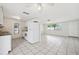Open kitchen with white cabinets, tiled floors, and modern appliances, perfect for cooking at 5706 Mockingbird Dr, New Port Richey, FL 34652