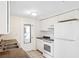 Functional kitchen with white appliances, countertops, ample cabinet space and tiled floors at 5706 Mockingbird Dr, New Port Richey, FL 34652
