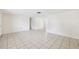 Bright living room featuring tile floors, neutral walls, and seamless flow to other spaces at 5706 Mockingbird Dr, New Port Richey, FL 34652